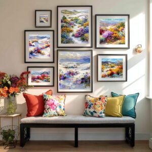 Floral desert wall art gallery wall with colorful boho watercolor prints of desert wildflowers in black frames above a bench with floral pillows. floral desert wall art printable